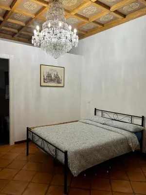 a bedroom with a bed with a chandelier at Domus Giovanna in Rome