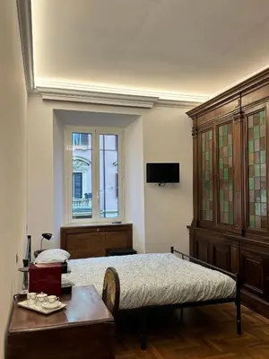 a bedroom with a bed and a table and a window at Domus Giovanna in Rome