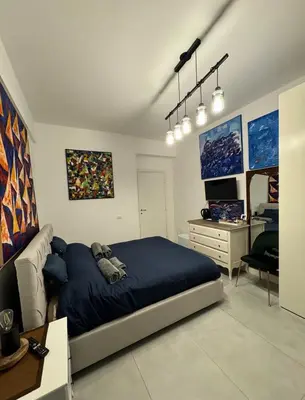 a bedroom with a bed and a desk in it at Mata Vatican Rooms in Rome