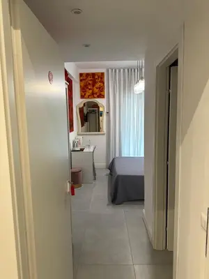 a bedroom with a bed and a desk in a room at Mata Vatican Rooms in Rome