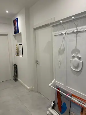 a white room with a door and a room with at Mata Vatican Rooms in Rome