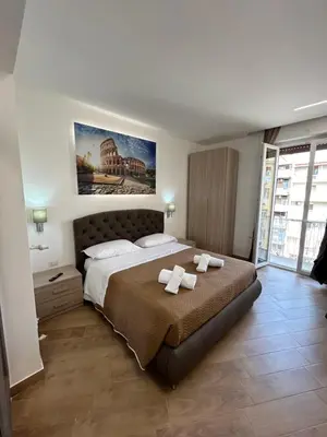 a bedroom with a large bed with two towels on it at Grimaldi Comfort Guest House in Rome