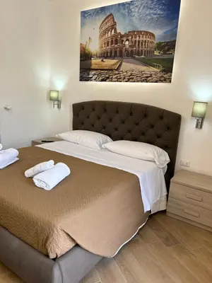 a bedroom with a large bed with two towels on it at Grimaldi Comfort Guest House in Rome