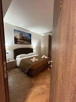 a bedroom with a bed and a painting on the wall at Grimaldi Comfort Guest House in Rome
