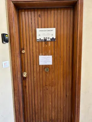 a wooden door with a sign on it at Grimaldi Comfort Guest House in Rome