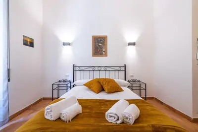 a bedroom with a bed with towels on it at Gianicolense Apartment in Rome