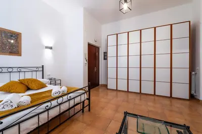 a bedroom with a bed and a large sliding door at Gianicolense Apartment in Rome