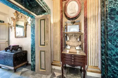 a room with a vase on a dresser and a mirror at Piazza Navona historical palace in Rome