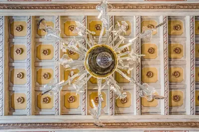 a metal snowflake on the ceiling of a building at Piazza Navona historical palace in Rome