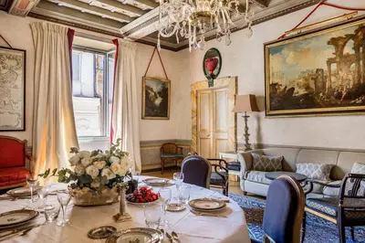 a dining room with a table and a couch at Piazza Navona historical palace in Rome