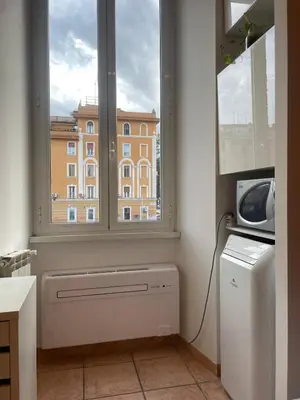 a window in a room with a heater and a building at Steph and Lorenzo's place in Rome