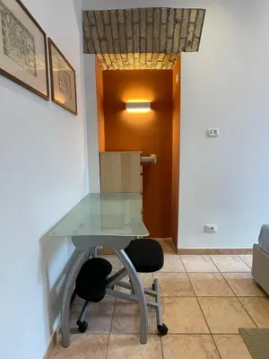 a glass table and two chairs in a room at Steph and Lorenzo's place in Rome