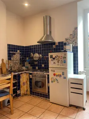 a kitchen with a stove and a white refrigerator at Steph and Lorenzo's place in Rome