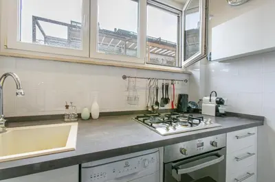 a kitchen with a sink and a stove top oven at La Terrazza di Vigna Clara in Rome