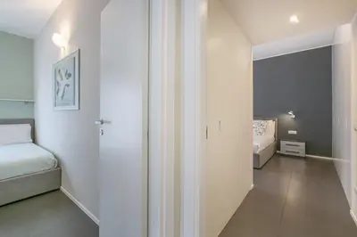 a small room with a bed and a room with a hallway at La Terrazza di Vigna Clara in Rome