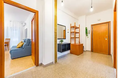 a bedroom with a large white bed and a lamp at Iolanda Fine & Spacious Flat in Rome