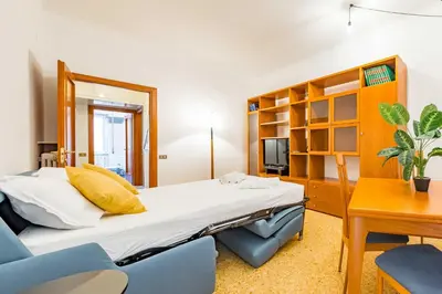 a bedroom with a bed and a large window at Iolanda Fine & Spacious Flat in Rome
