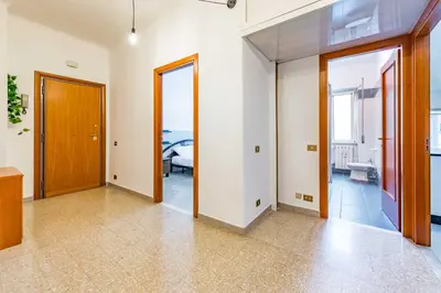 a white bathroom with a sink and a toilet at Iolanda Fine & Spacious Flat in Rome