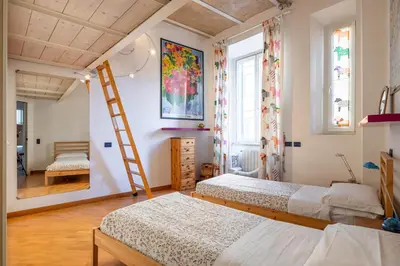 a bedroom with two beds and a ladder at New Trastevere Home: big, elegant, comfy apartment in Rome