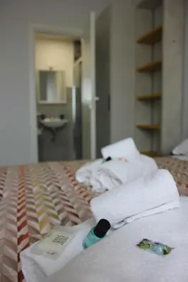 a pile of towels on a bed in a bathroom at Dolce Titina Affittacamere in Rome