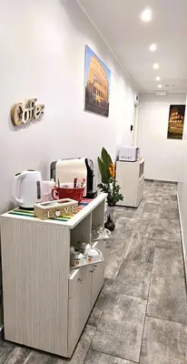 an office with a counter with a coffee sign on the wall at Dolce Titina Affittacamere in Rome
