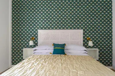 a bedroom with a large bed with a wall covered in wallpaper at Domus Vatican View - San Pietro in Rome