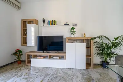 a living room with a tv and a white entertainment center at Domus Vatican View - San Pietro in Rome