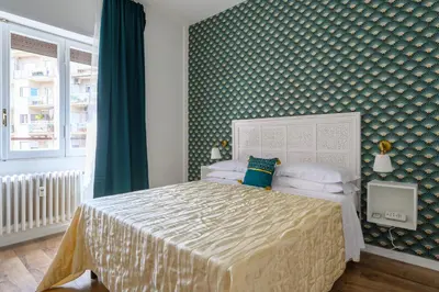 a bedroom with a bed and a green wall at Domus Vatican View - San Pietro in Rome