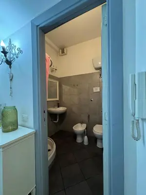 a bathroom with two toilets and two sinks at Blancmaisonteveresuite in Rome