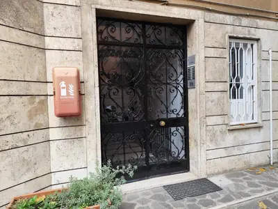 a black door with a sign in front of it at Appartamento Suite Ponte Milvio in Rome
