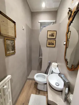 a bathroom with a white toilet and a sink at Appartamento Suite Ponte Milvio in Rome