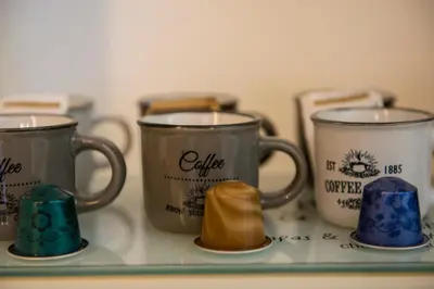 a group of three coffee mugs sitting on a counter at New special vrbs Roma apartament in Rome