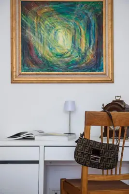 a desk with a chair and a painting on the wall at New special vrbs Roma apartament in Rome