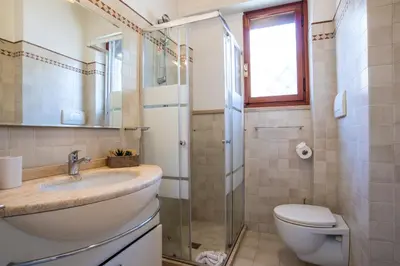 a bathroom with a toilet and a sink and a shower at New special vrbs Roma apartament in Rome