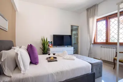 a bedroom with a large bed with purple and white pillows at New special vrbs Roma apartament in Rome