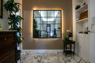 a hallway with a mirror and a room with plants at New special vrbs Roma apartament in Rome