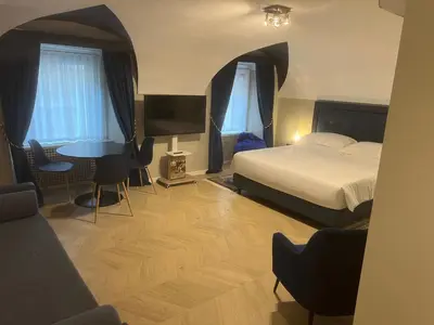 a bedroom with a bed and a desk and a table at Rome luxury blue suites- IMPERIAL in Rome