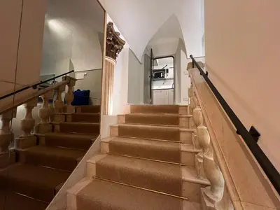 a staircase in a house with brown carpet at Rome luxury blue suites- IMPERIAL in Rome