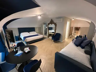 a hotel room with a bed and a table at Rome luxury blue suites- IMPERIAL in Rome