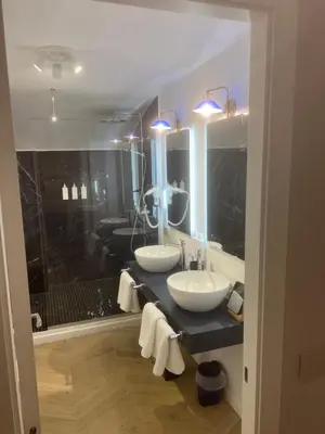 a bathroom with two sinks and a large mirror at Rome luxury blue suites- IMPERIAL in Rome