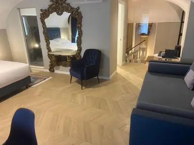 a living room with a bed and a mirror at Rome luxury blue suites- IMPERIAL in Rome