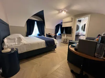 a bedroom with a large bed with an arched ceiling at Rome luxury blue suites- LOVE in Rome