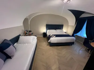 a hotel room with two beds and an umbrella at Rome luxury blue suites- LOVE in Rome