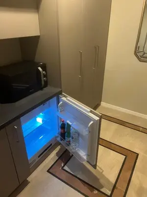 an empty refrigerator with drinks inside of it at Rome luxury blue suites- LOVE in Rome