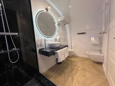 a bathroom with a sink and a mirror at Rome luxury blue suites- LOVE in Rome
