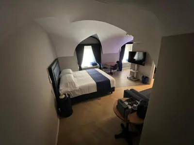 a bedroom with a bed and a desk and a chair at Rome luxury blue suites- LOVE in Rome