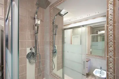 a bathroom with a shower and a sink and a mirror at Appia Luxe - A poche fermate del Centro in Rome
