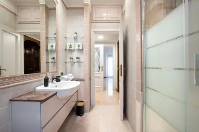 a bathroom with a sink and a glass shower at Appia Luxe - A poche fermate del Centro in Rome