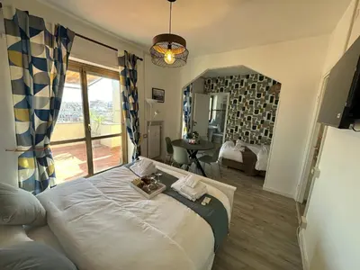 a bedroom with a large bed with a large window at Attico al Settimo Piano in Rome