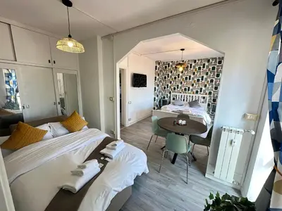 a bedroom with a large bed and a table at Attico al Settimo Piano in Rome